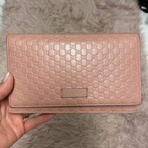Pink Gucci wallet/clutch. There are pen marks inside the inner flap and no strap
